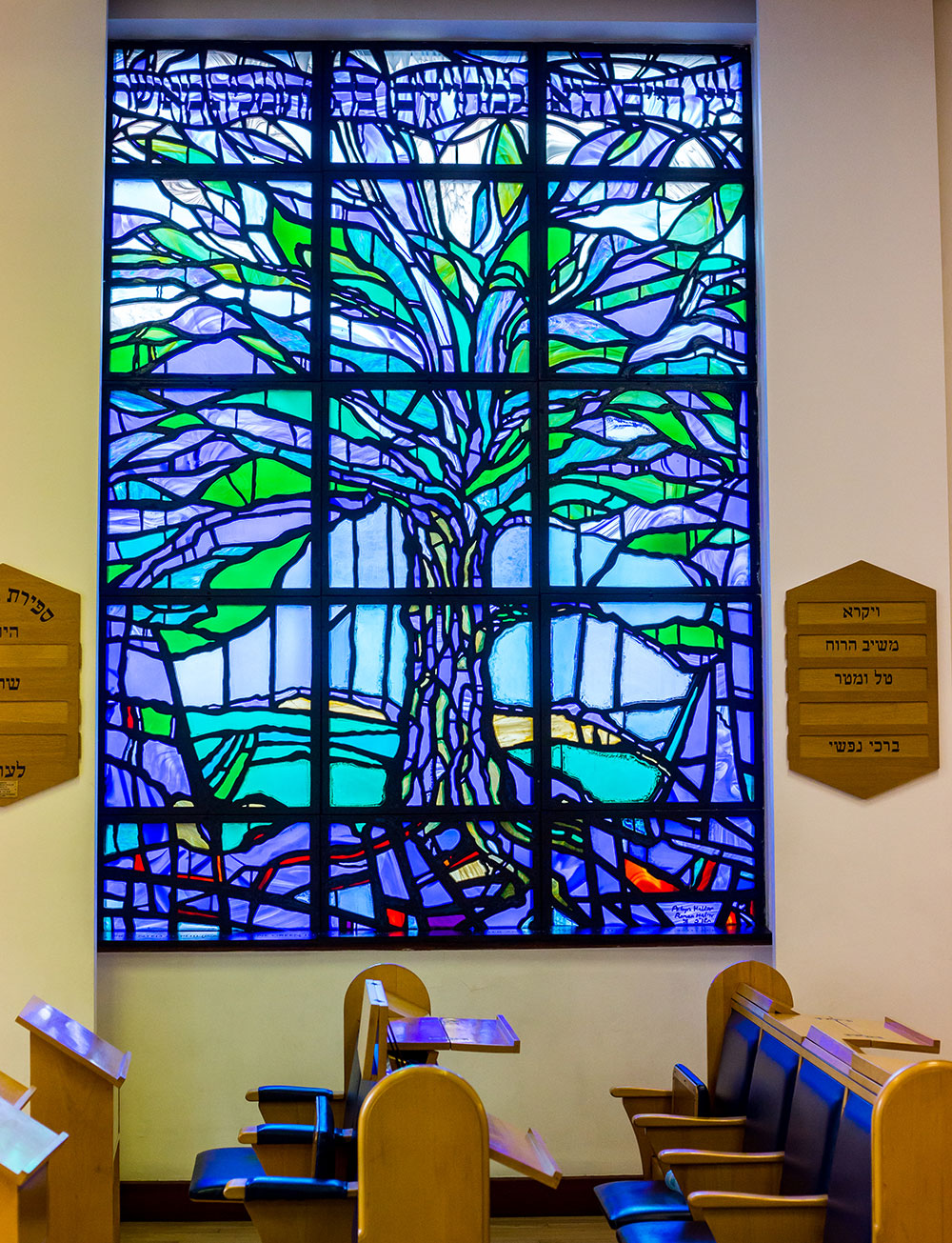 Stained glass window depicting a tree, in the sanctuary at Shul in the Wood
